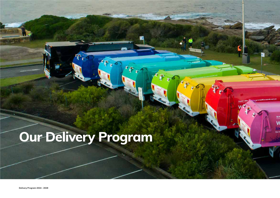 A group of garbage trucks in a parking lot

Description automatically generated
