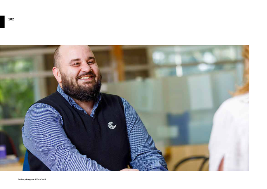 A person smiling at another person

Description automatically generated