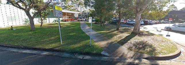A sidewalk and sign in a park

Description automatically generated with medium confidence